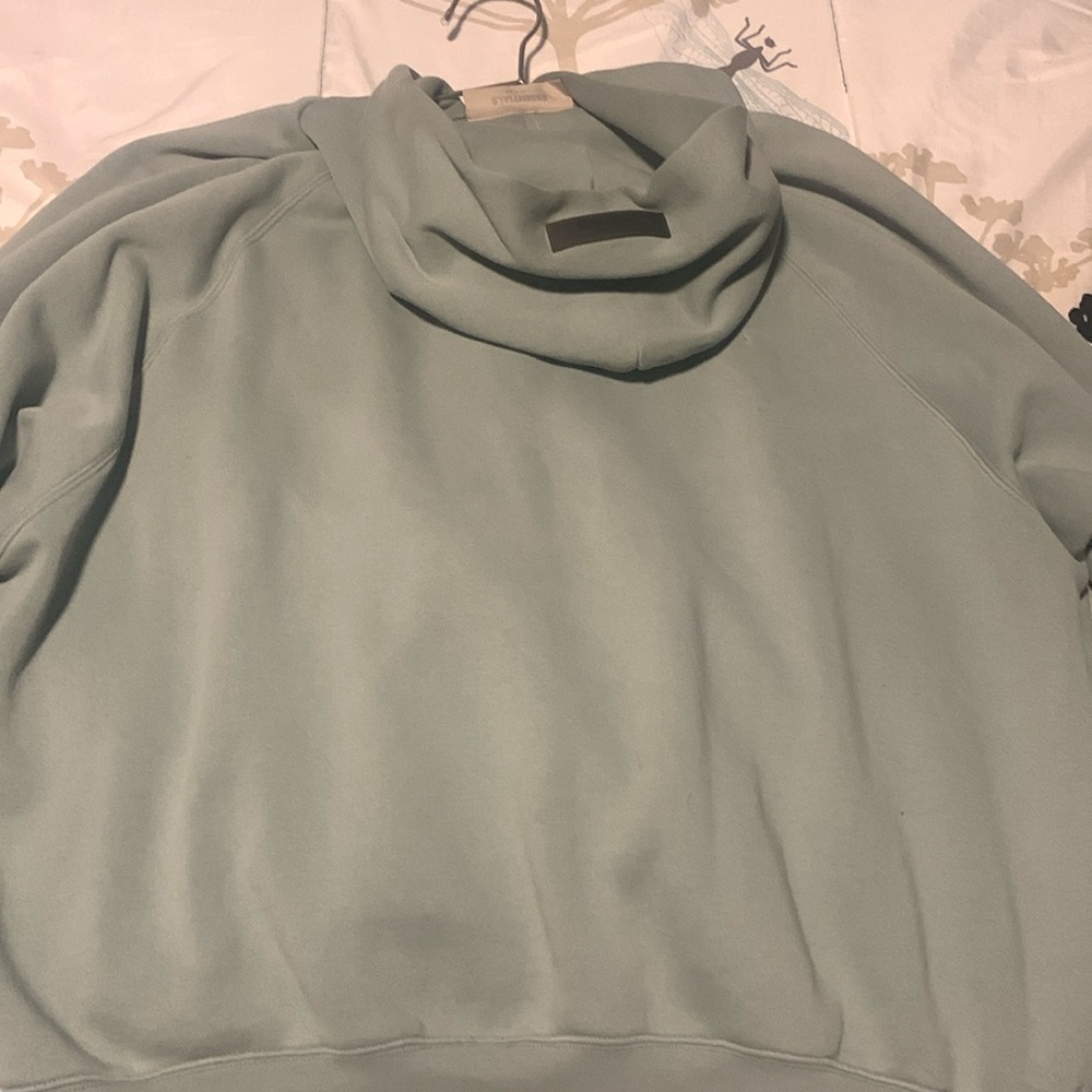 greenish blue essentials Hoodie